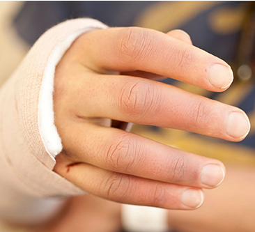 A person's hand with a bandage on it.